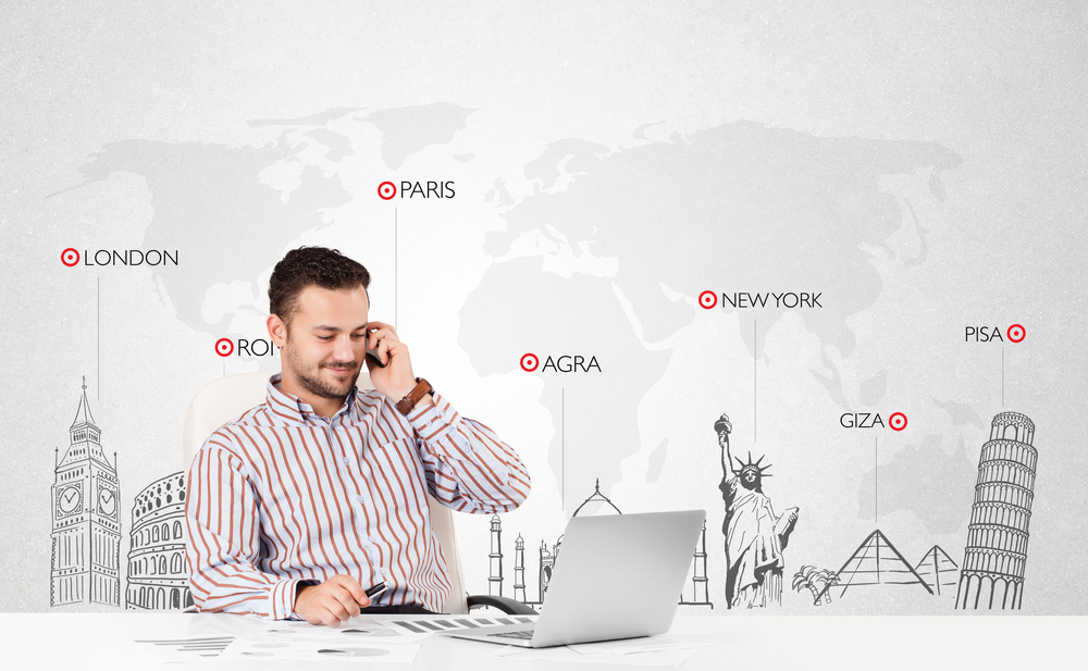 Handsome young businessman with world map and major landmarks of the world